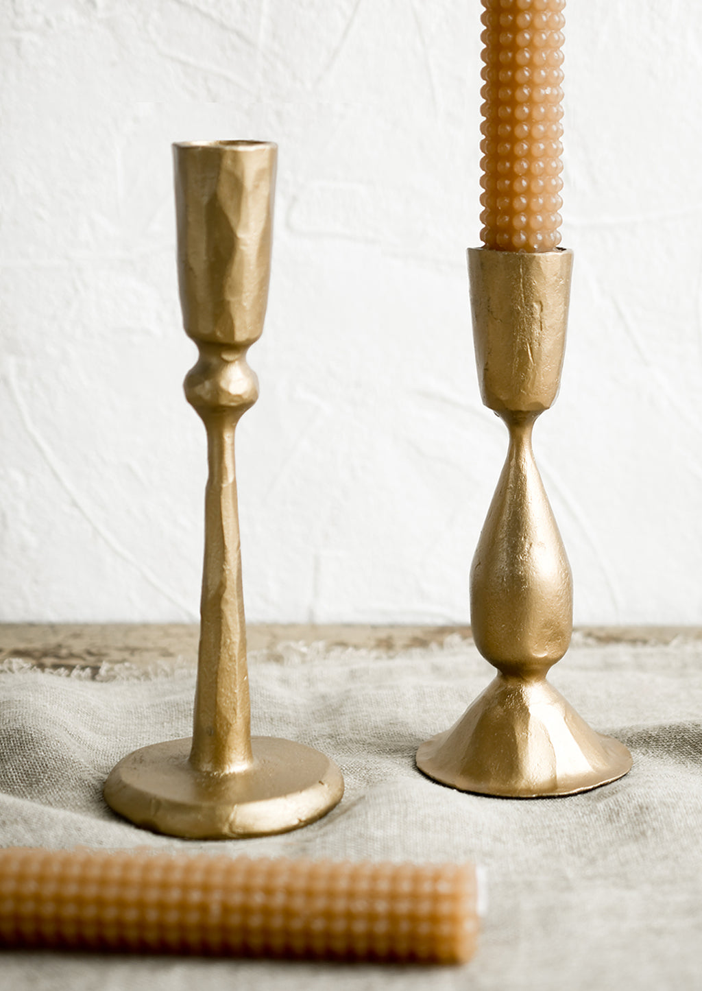 3: Golden metal candlestick holders with hobtail taper candles.
