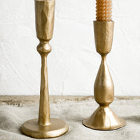 3: Golden metal candlestick holders with hobtail taper candles.