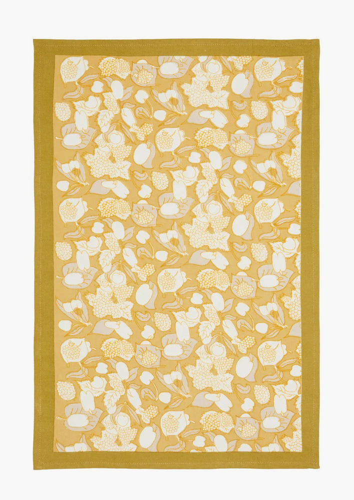 2: A gold, grey and white fruit print tea towel.