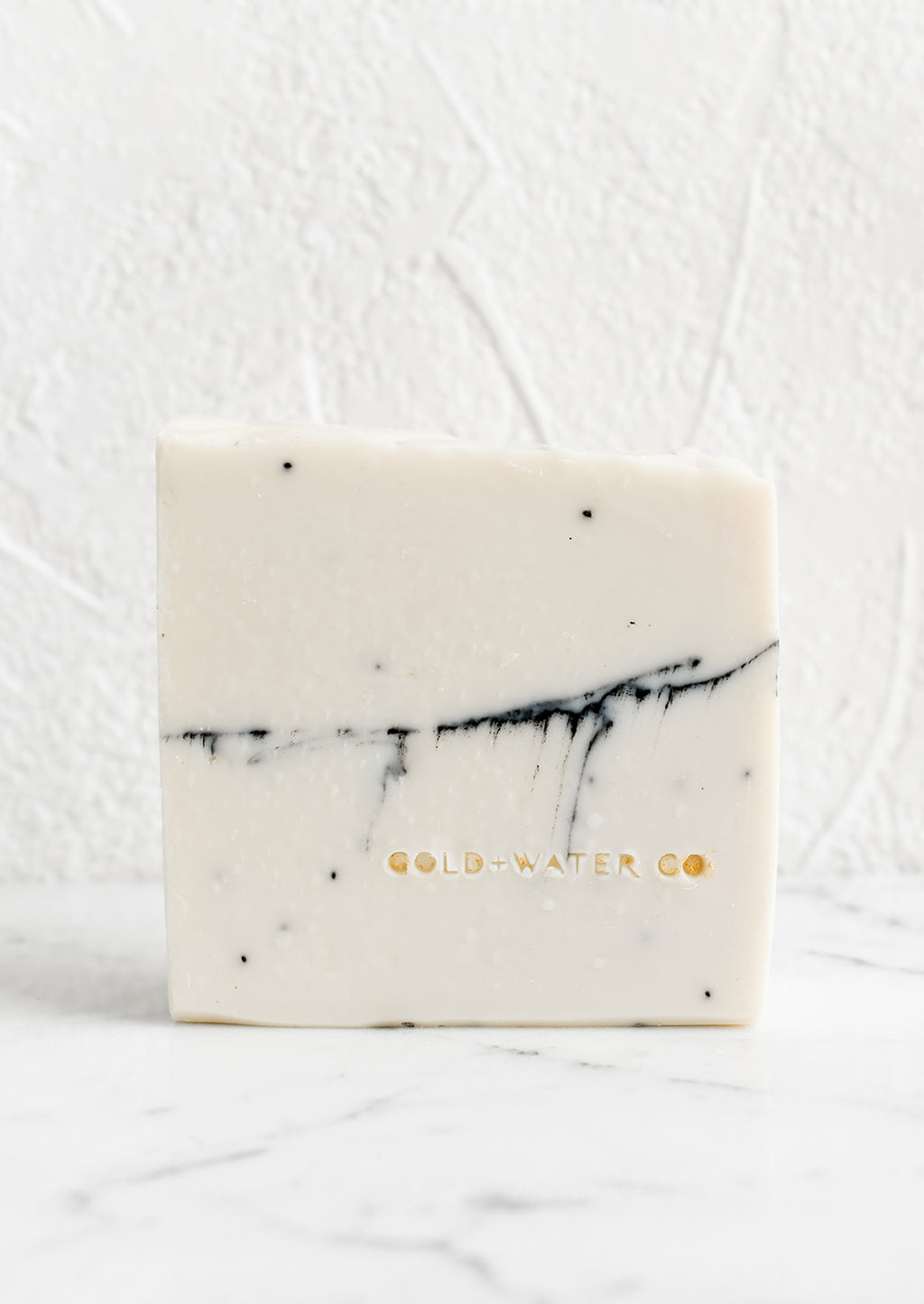 Mon Coeur: A white bar of soap with brand stamp at corner.