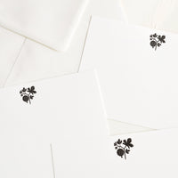 3: Three identical white notecards with small black botanical design.