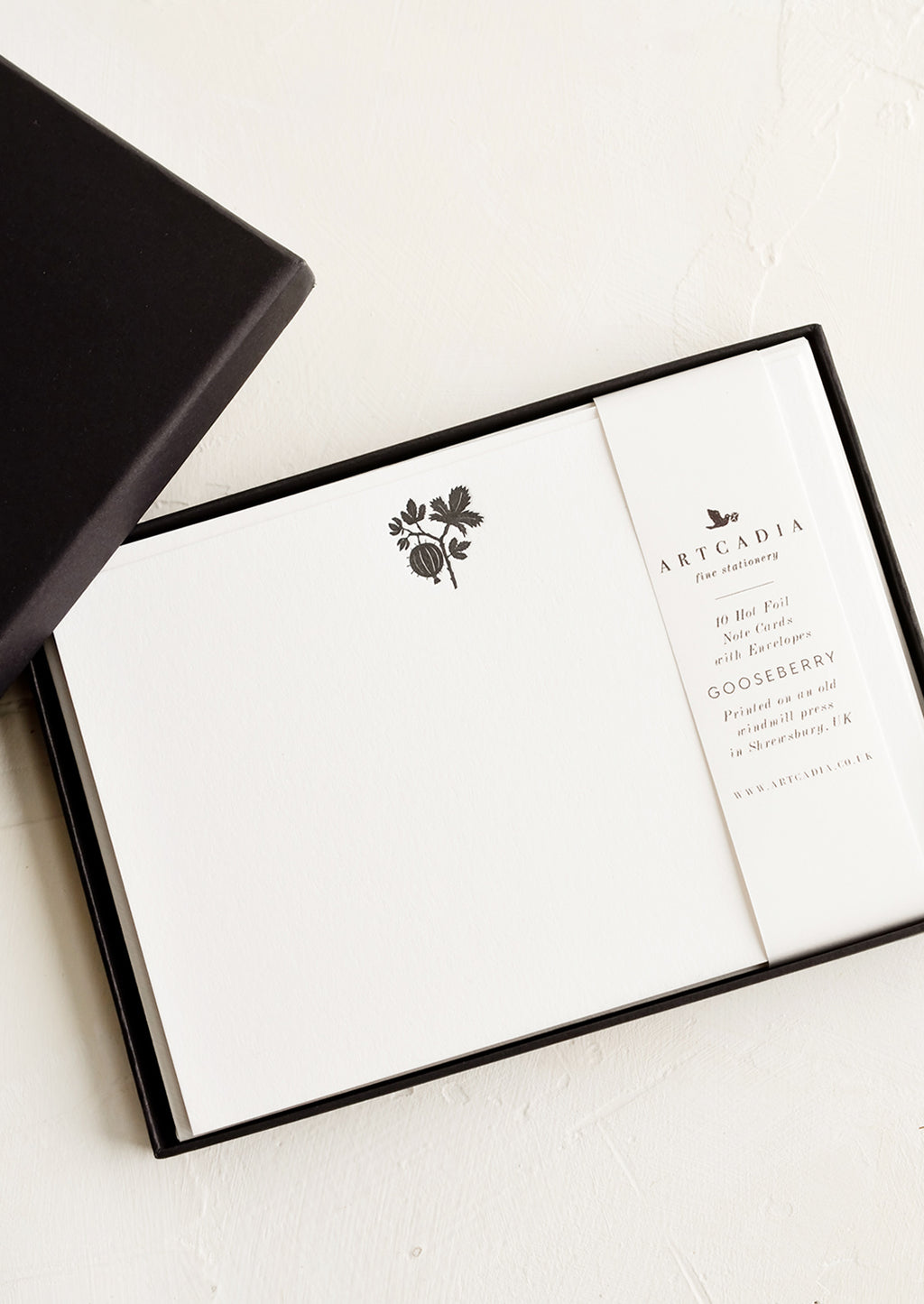 2: A black gift box containing botanical print stationery notecards.