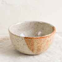 Two Tone Speckle: A small ceramic bowl in half & half speckled white and rust.