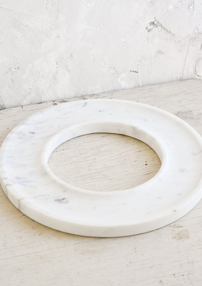 1: A circular white marble tray with an empty center.