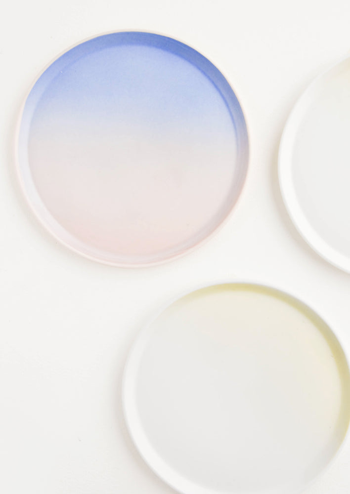 Three colorful ombre porcelain plates.