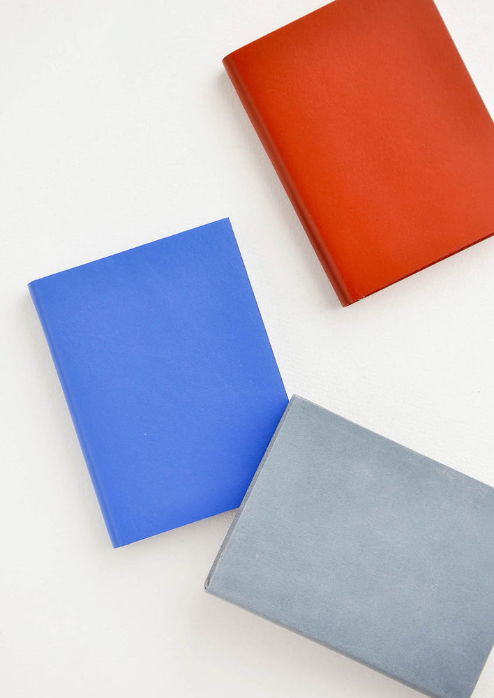 1: Product shot featuring multiple colors of leather notebook.