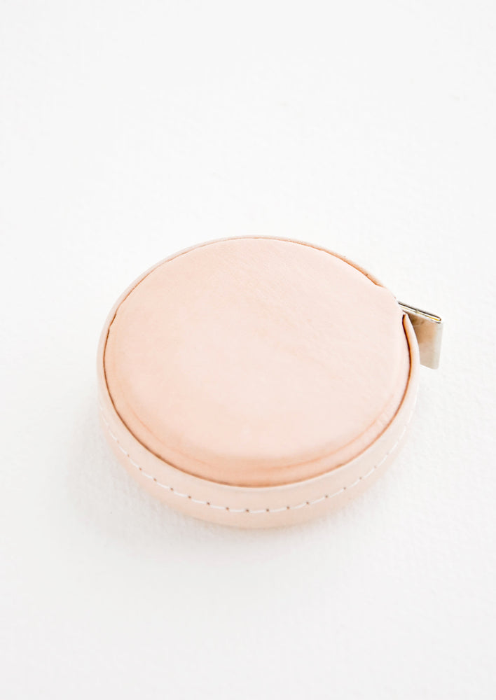 Natural: Tape measure covered in natural leather.