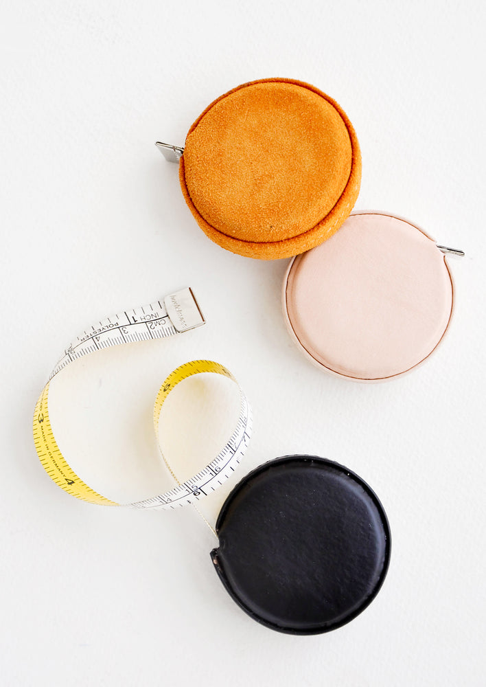 Mustard Suede: Product shot featuring multiple styles of leather covered tape measures.