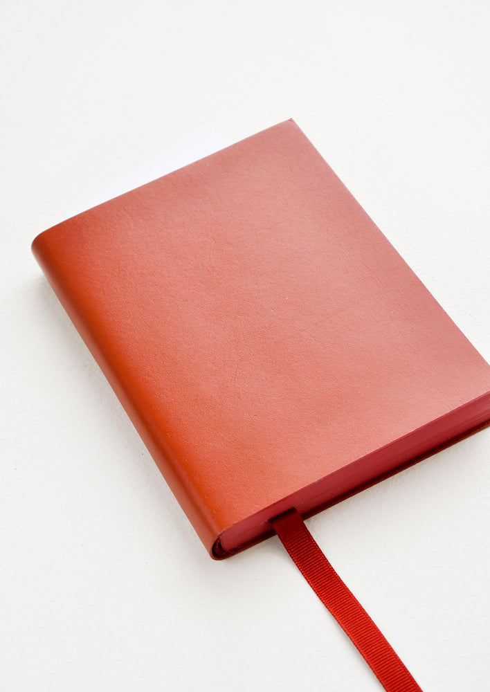 Rust brown leather notebook with grosgrain ribbon bookmark.