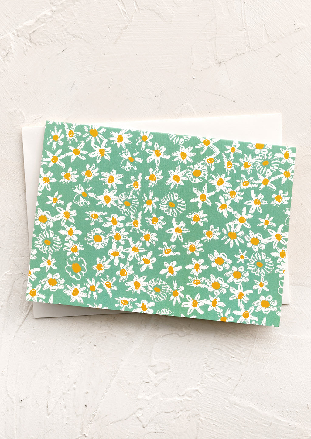 3: A green daisy print notecard.