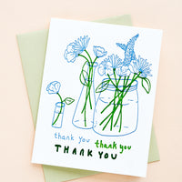 2: A letterpress printed thank you card with image of flowers in vases, with a mint green envelope.