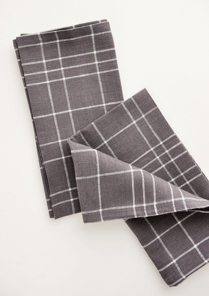 Pair of fabric dinner napkins in grey and white grid pattern