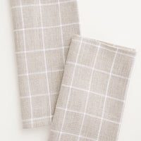 Flax Grid: Pair of fabric dinner napkins in beige and white grid pattern