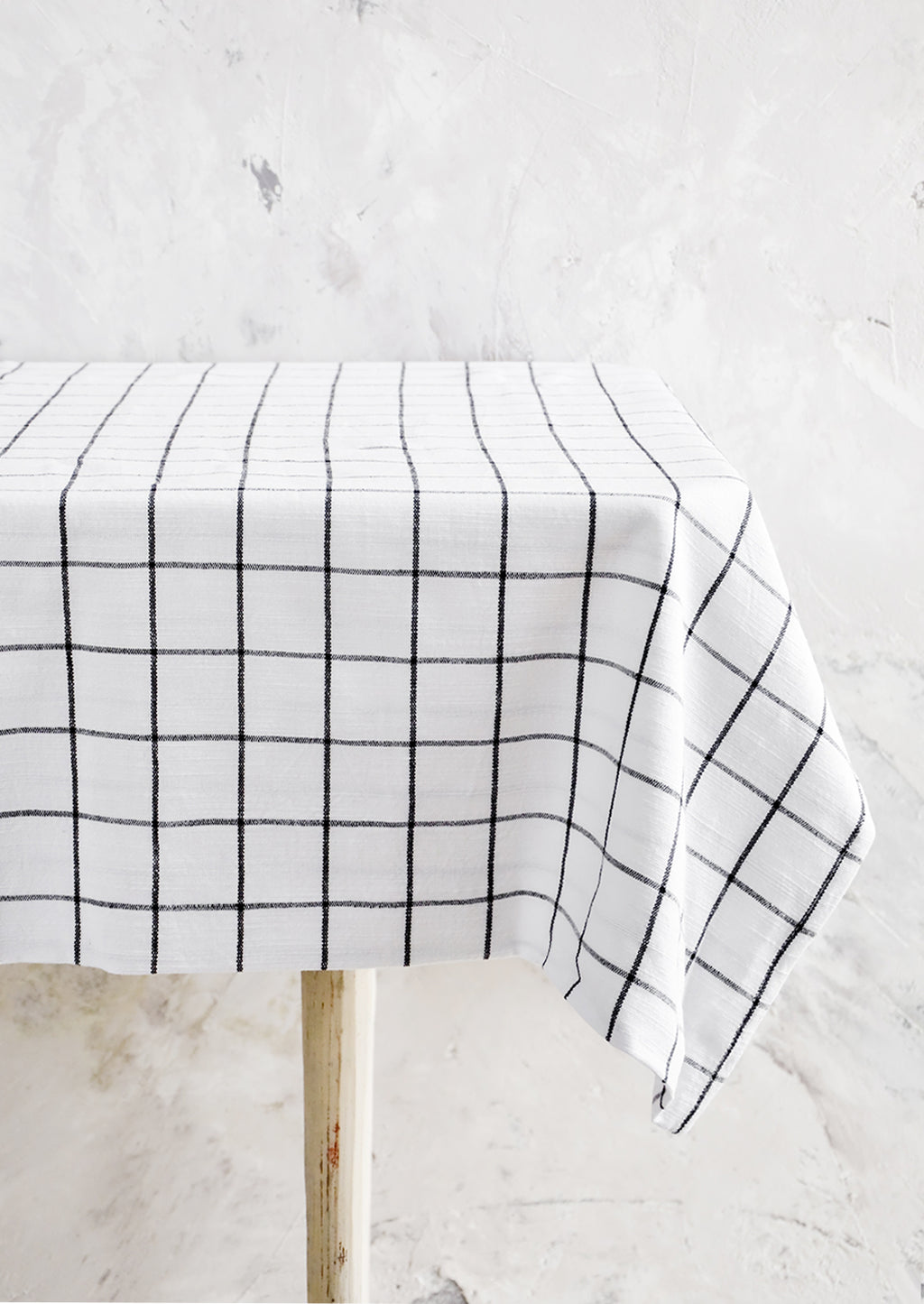 1: Black and white grid patterned tablecloth displayed over table