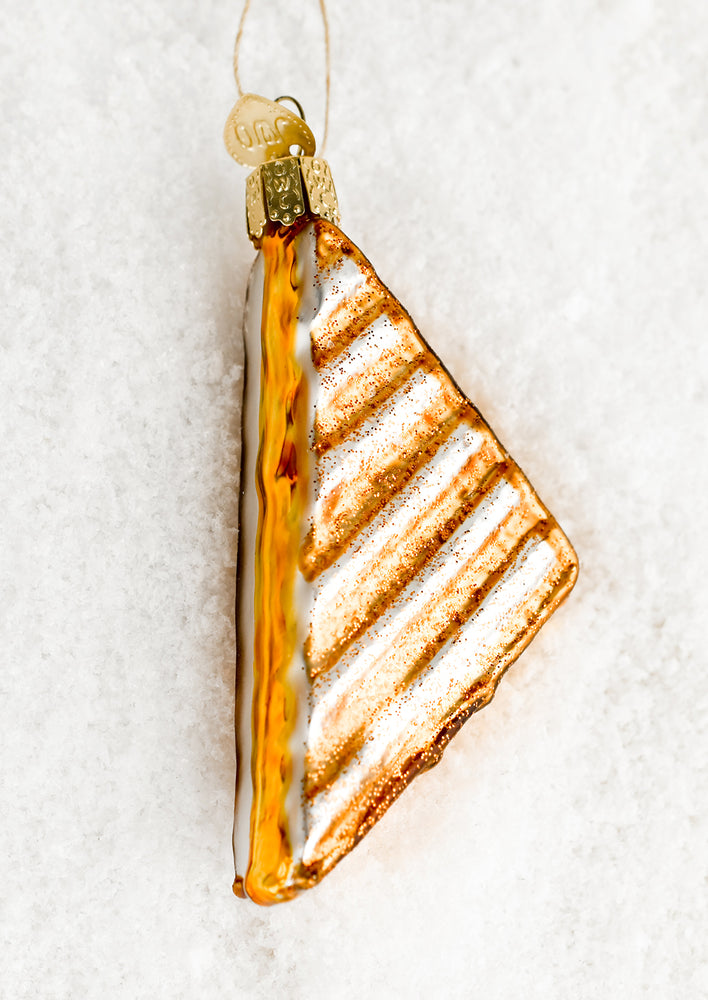 An ornament of half a grilled cheese sandwich.