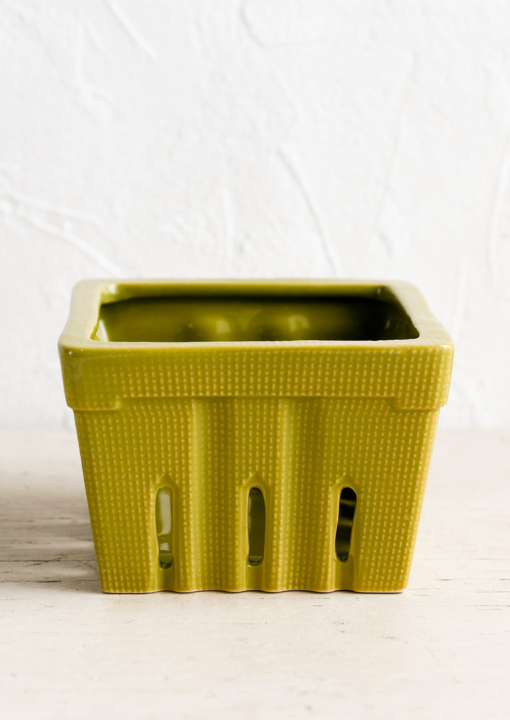 Moss Green: A ceramic berry basket in moss green.
