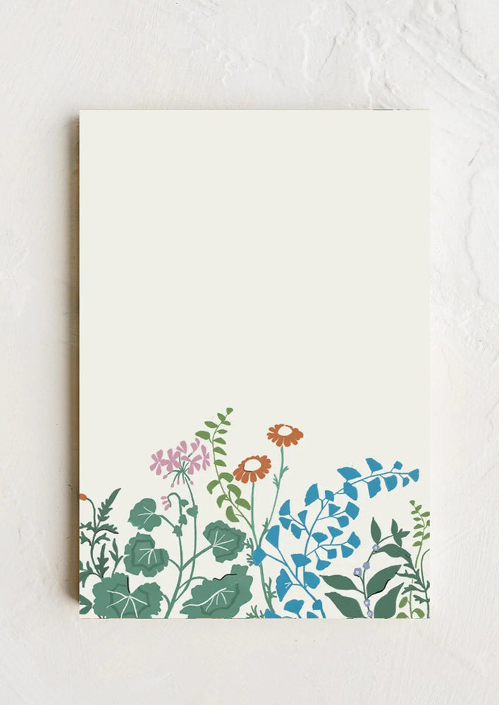 A floral botanical print notepad in ivory.