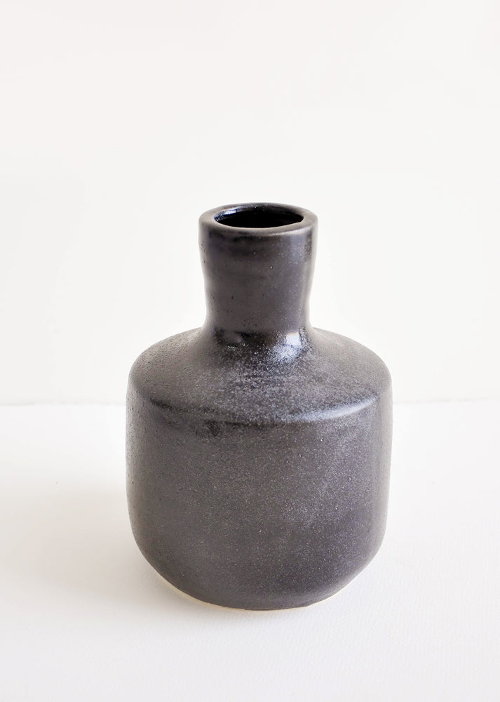 Glossy black ceramic vase with wide base and narrow opening