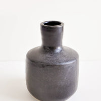 1: Glossy black ceramic vase with wide base and narrow opening