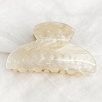 Pearl: A plastic hair claw in pearlized ivory.