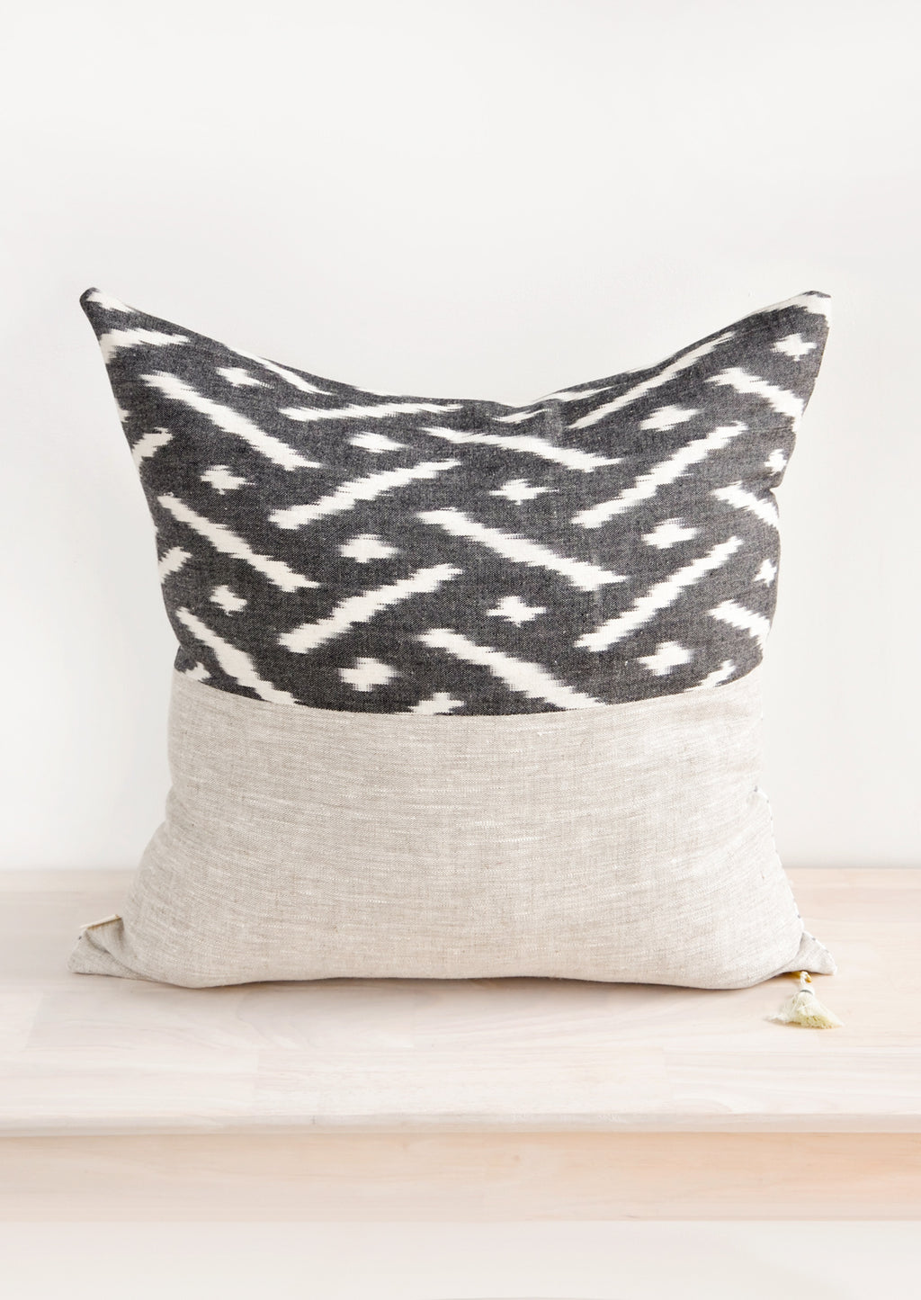2: Square throw pillow in reversible design with contrasting black and white fabric on front and back