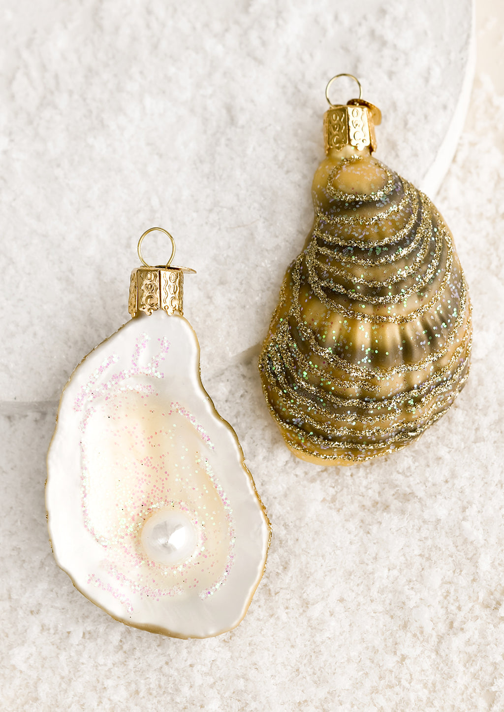 1: Holiday ornaments in the shape of front and back of a half oyster shell.