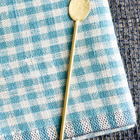 Cocktail Spoon: A long, skinny hammered gold spoon with slim, round handle.