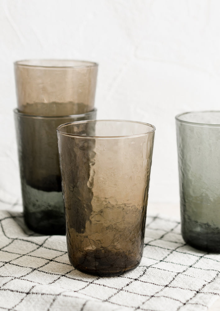 Hammered glass cups in brown and charcoal tints.