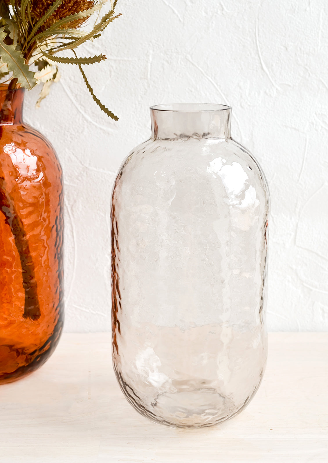 Tall glass vases with hammered texture.