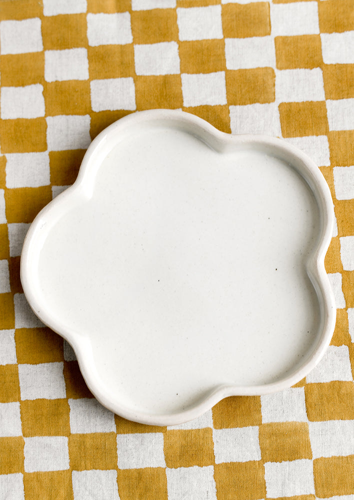 A white flower shaped ceramic plate.