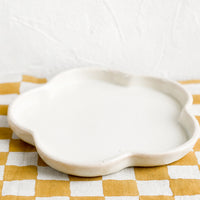2: A white flower shaped ceramic plate.