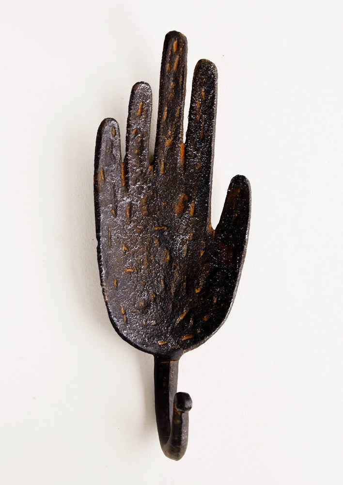1: Wall hook in the shape of a hand, made in dark distressed metal