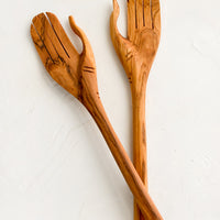 2: A pair of wooden salad servers carved in the shape of a pair of hands.