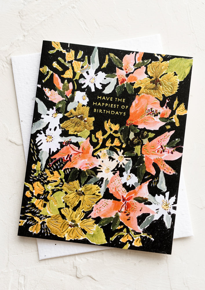 A floral print card reading "have the happiest of birthdays".