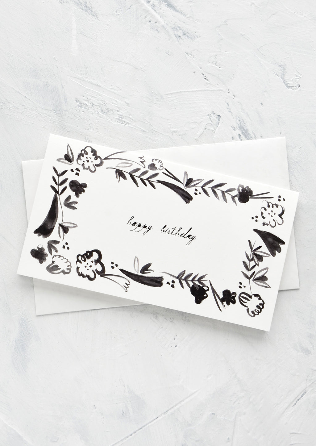 2: Black and white greeting card with floral frame around "happy birthday" script at middle
