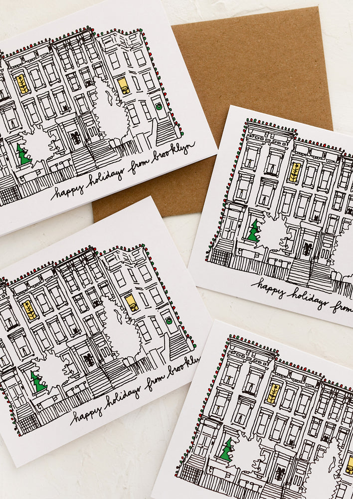 A set of cards with drawing of brownstone and text reading "Happy holidays from Brooklyn".