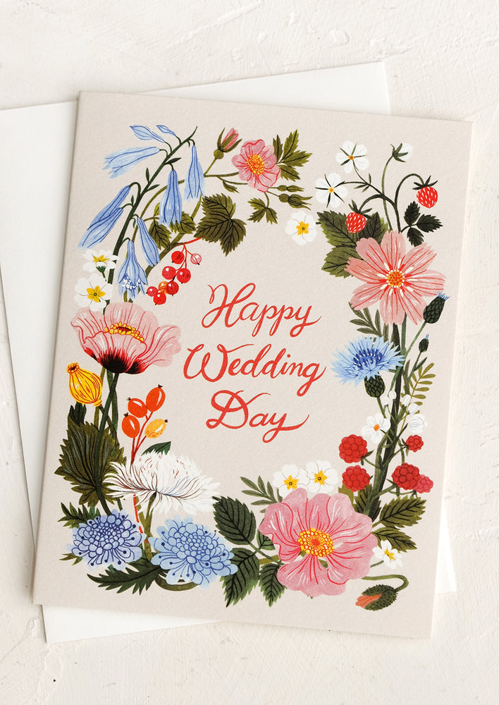 A card with floral border reading "Happy wedding day".