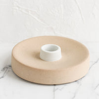 Single / Sand / White: A round ceramic taper candle holder in sand.