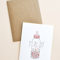 1: Greeting card with baby bottle filled with confetti and "YAY!" text