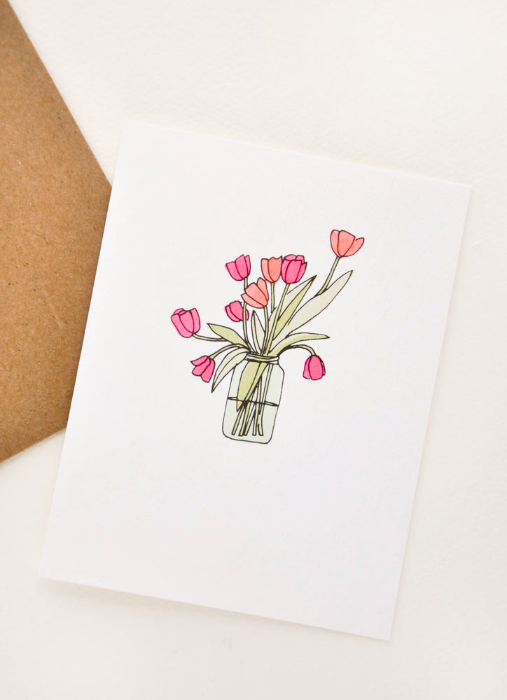 A greeting card with illustration of tulips in a glass vase.
