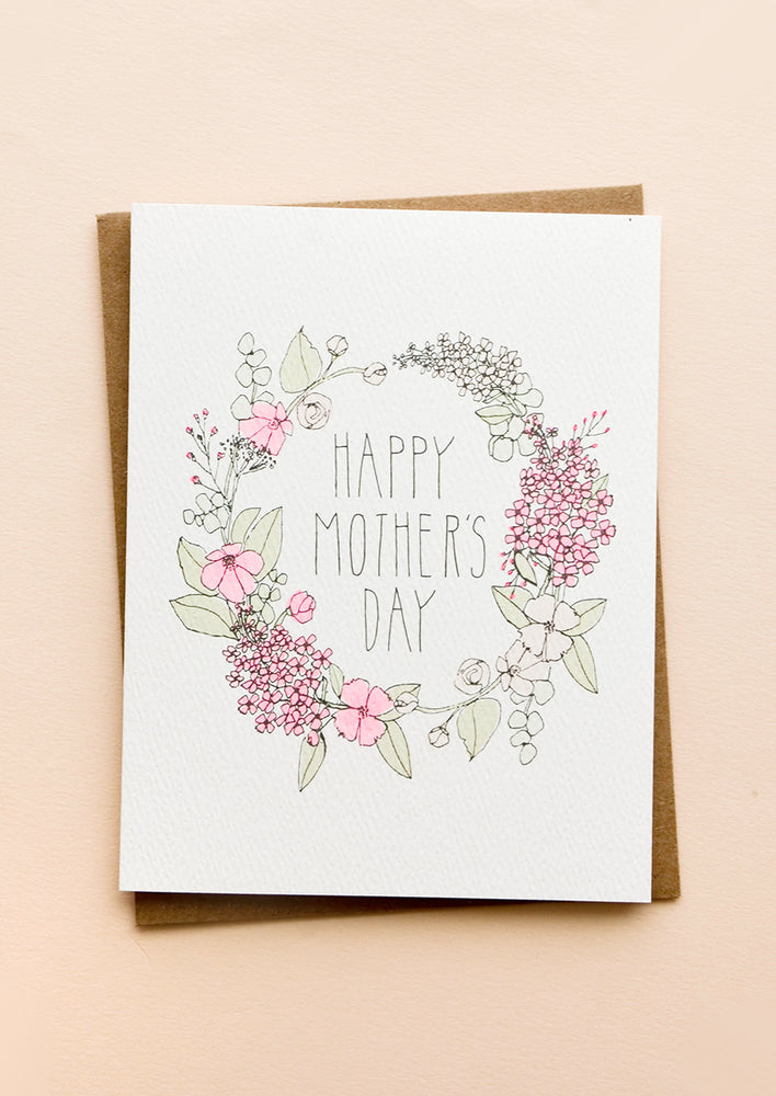 Greeting card with illustrated floral wreath and "Happy Mother's Day" printed in center