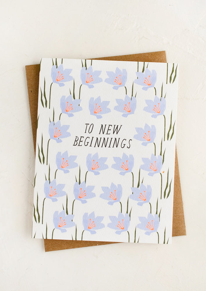 1: A floral printed greeting card with text reading "To New Beginnings".