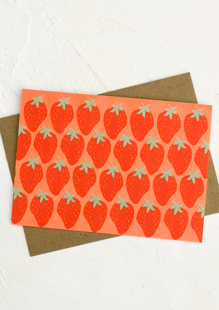 A red and pink strawberry print card.