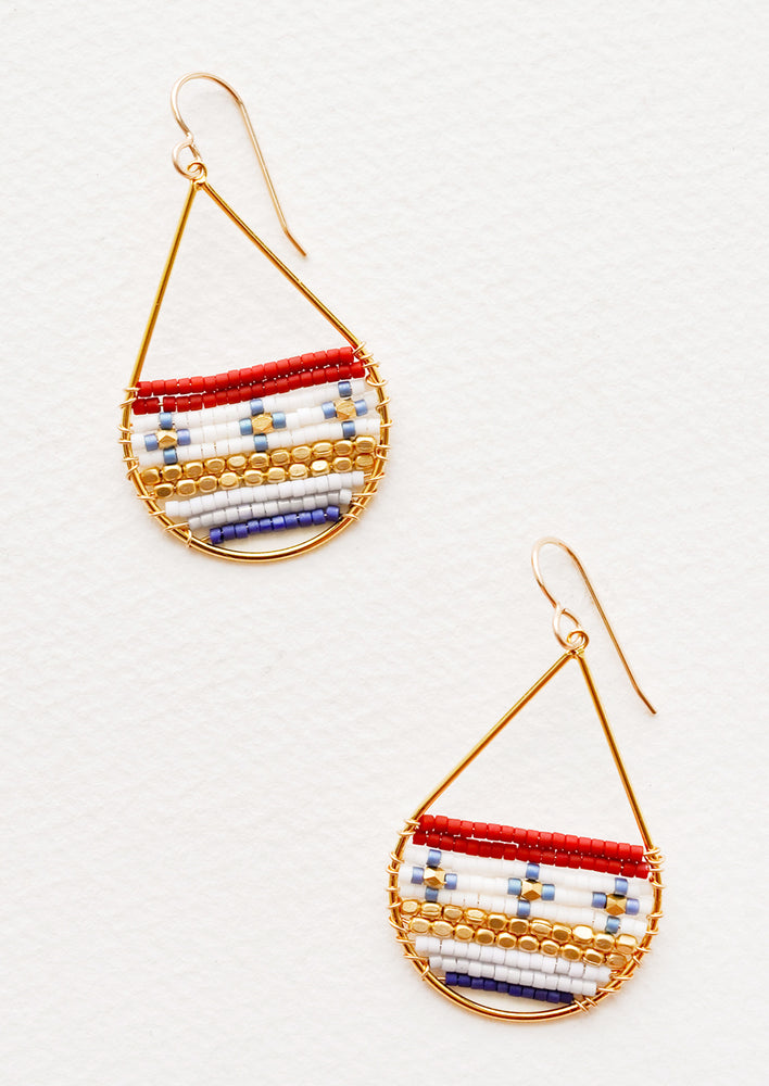 Gold teardrop shaped earrings with deep red, white, blue, and gold glass beads filling bottom half of teardrop.