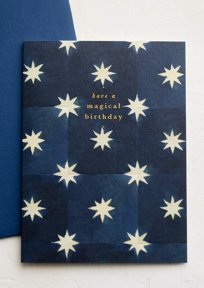 1: A star print navy blue card with gold text reading "Have a magical birthday".