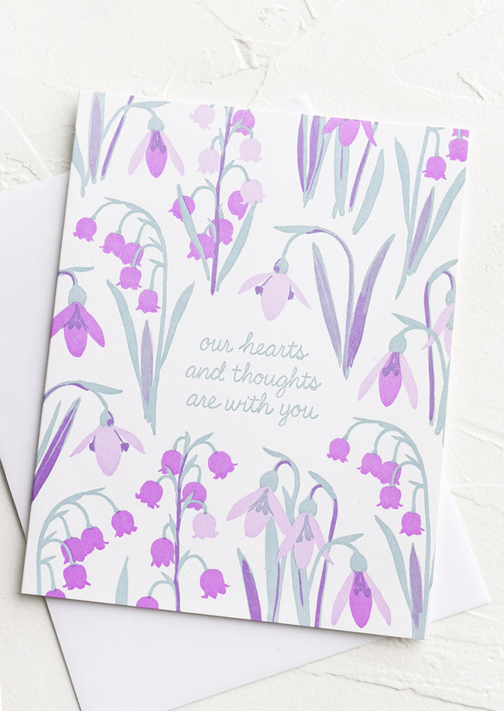 A floral print greeting card reading "our hearts and thoughts are with you".