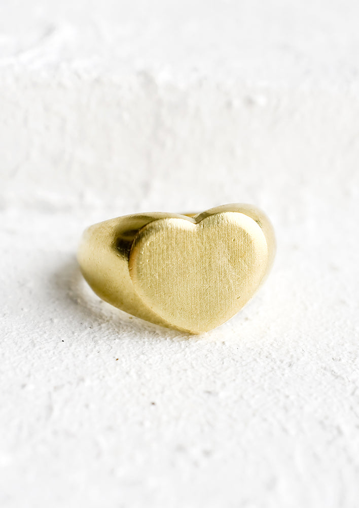 A brass ring in heart shape signet style.