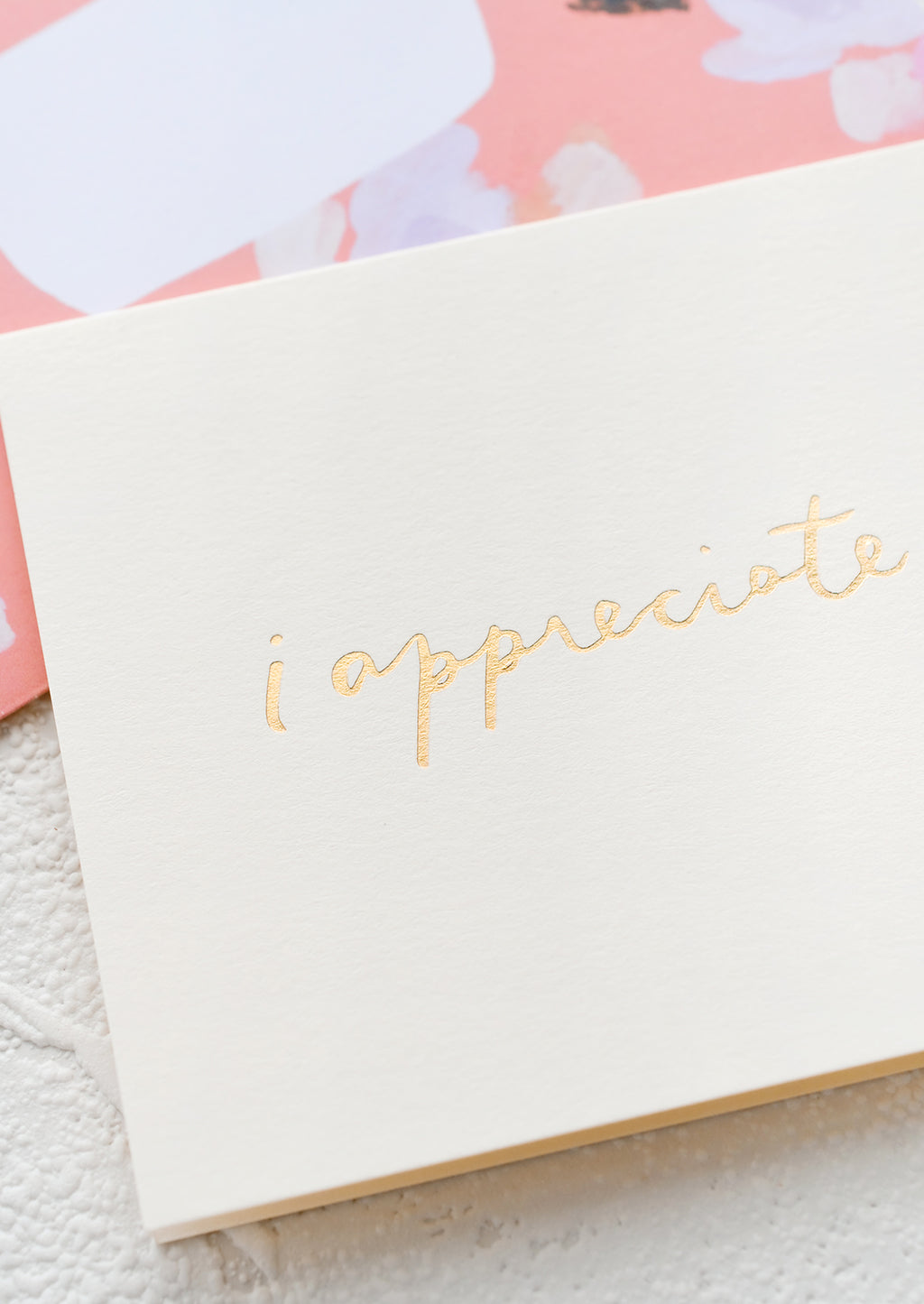 2: A white greeting card with golden cursive reading "I Appreciate You".