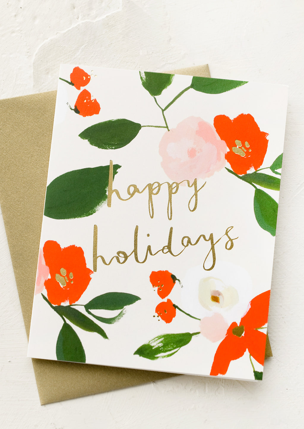 Single Card: A red and green floral print greeting card with "Happy holidays" in gold script.