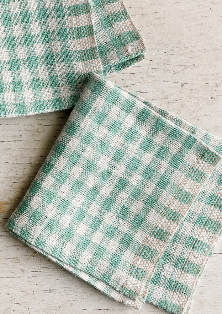 A pair of spearmint gingham cocktail napkins.